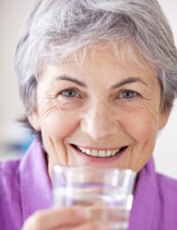 Grey Haired Woman With Glass